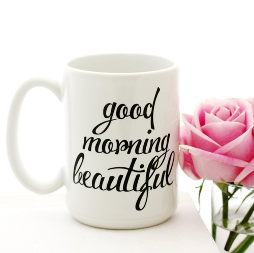 A mug with the words good morning and a pink rose