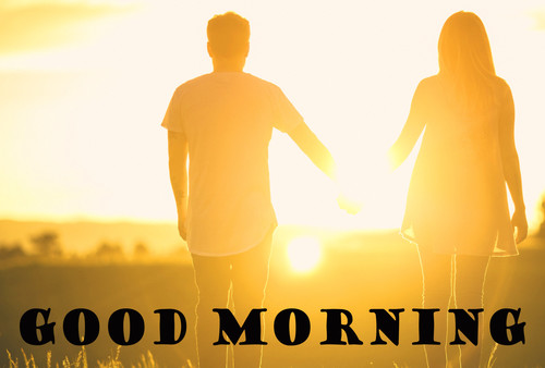A guy and a girl holding hands at dawn